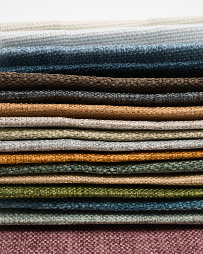 Zoe Linen Look swatch book featuring 17 colorful fabric samples for custom curtains, highlighting the woven linen texture.