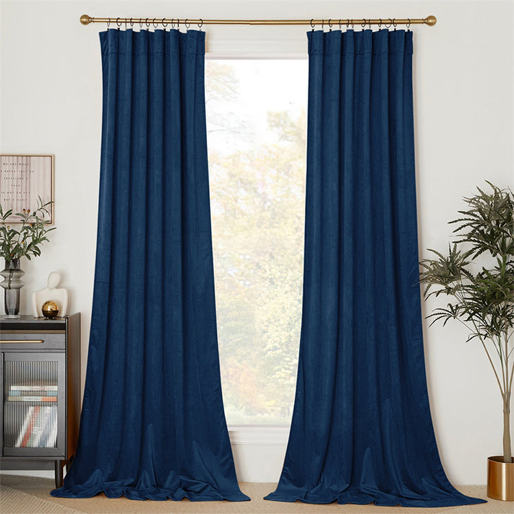 Luxurious deep blue velvet custom curtains hanging on a gold rod, offering elegant privacy and light control for home decor.