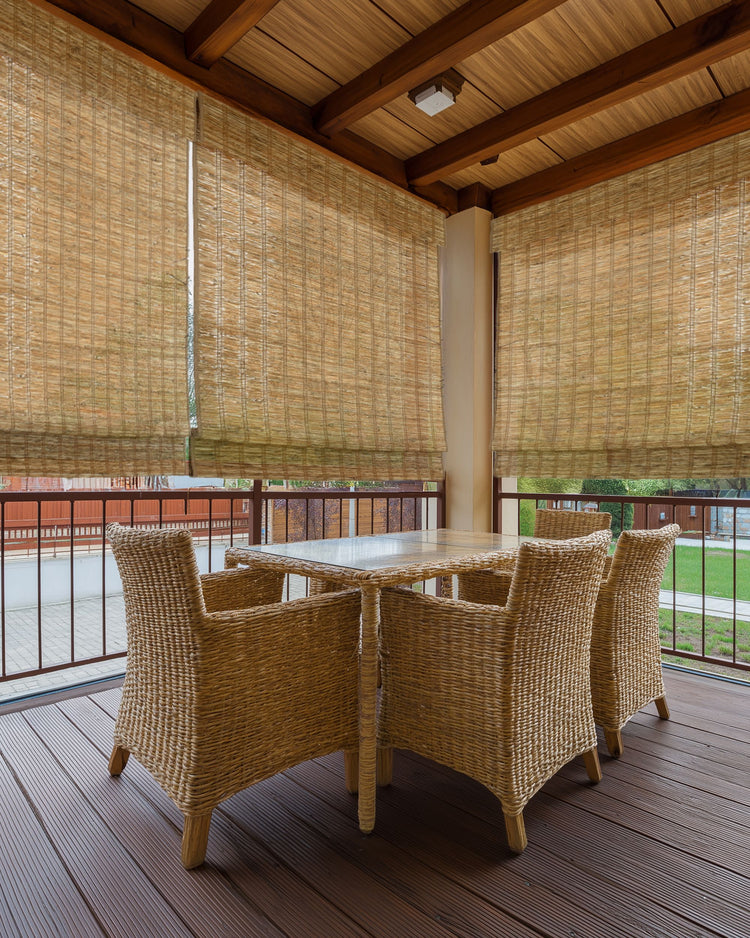 Hay Rumi Jute outdoor woven shades on a covered patio, offering natural texture, light control, and privacy.