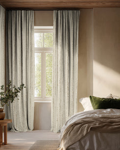 Sahara 100% blackout linen blend custom curtains with elegant textured patterns, providing superior light control in a sophisticated bedroom.