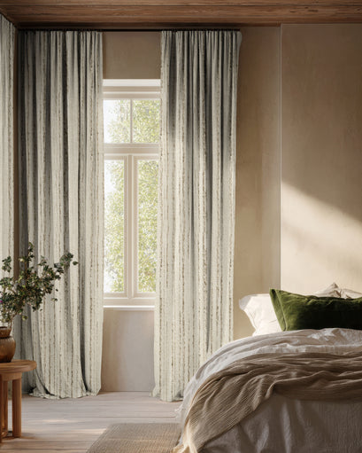 Sahara 100% blackout linen blend custom curtains with elegant textured patterns, providing superior light control in a sophisticated bedroom.