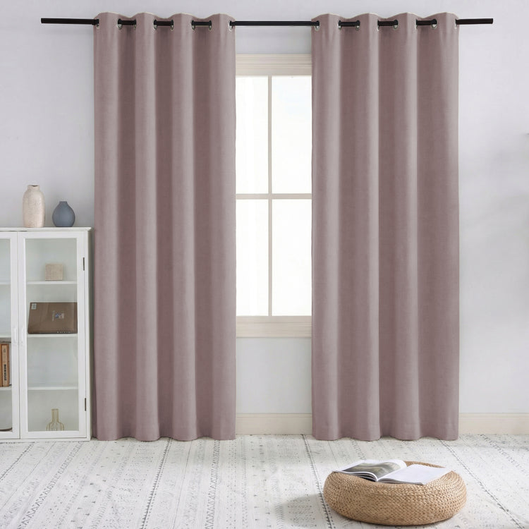 Neutral taupe linen blend custom pinch pleat curtains for 100% blackout. Elegant drapery framing a window in modern home decor.