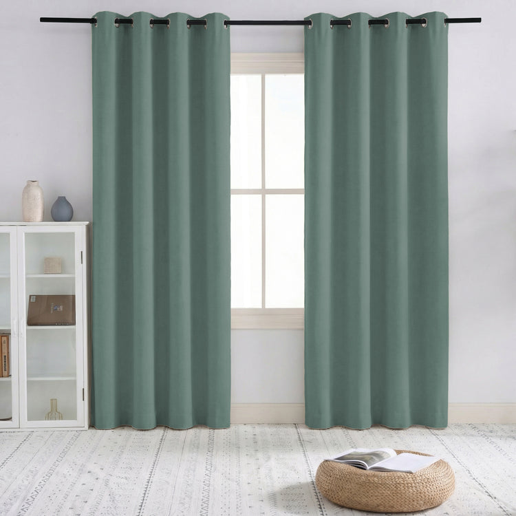 Sage green Sally 100% blackout linen blend custom curtains with elegant pinch pleats, providing total light control for a room.