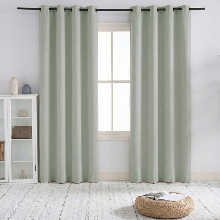 Pair of Sally 4-layer 100% blackout linen blend custom curtains in light green with pinch pleat header style, on a window.
