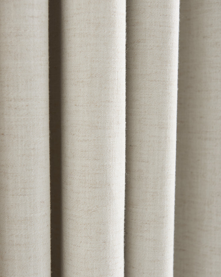 Detailed view of Sally Linen Blend fabric swatch in light beige, highlighting its natural slub texture and soft drapery folds.