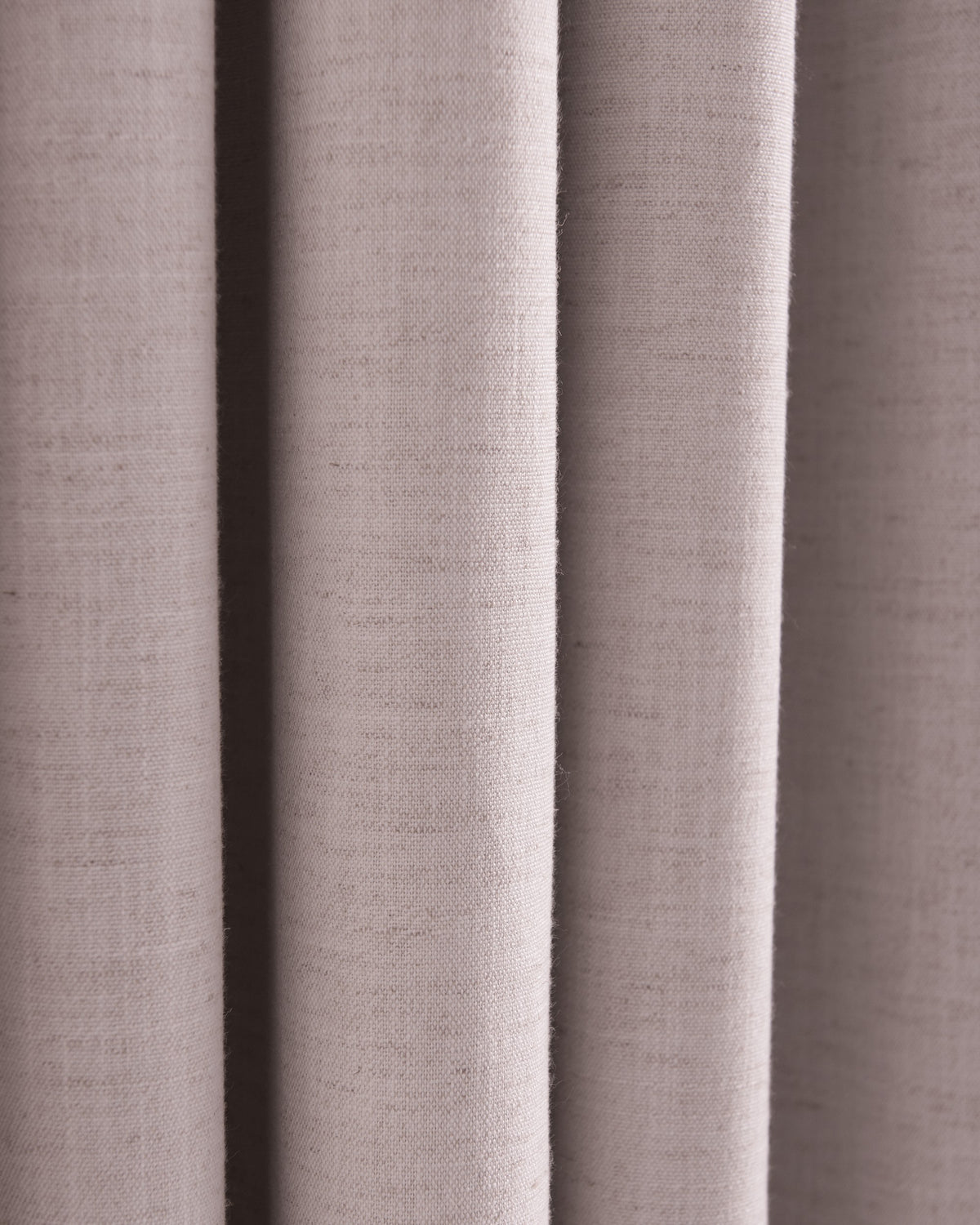 Close-up of Sally Linen Blend custom drapery fabric, revealing its subtle woven texture and elegant natural folds for window treatments.
