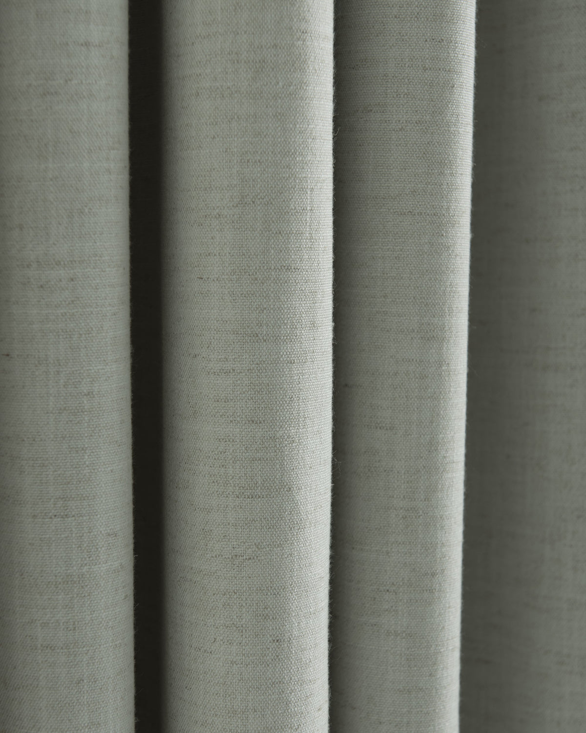 Close-up of folded Sally Linen Blend fabric swatch, showcasing its natural texture for custom drapery.