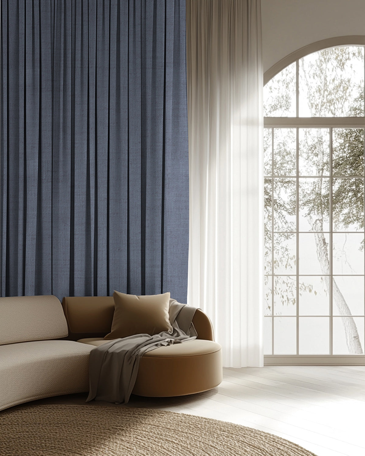 Deep blue custom linen blend drapery in a chic living room, alongside sheer white window treatments on an arched window.