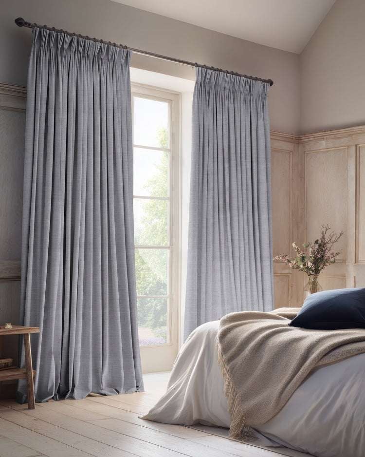 Grey Sally 100% blackout linen blend custom curtains with elegant pleats, providing privacy and light control in a serene bedroom.