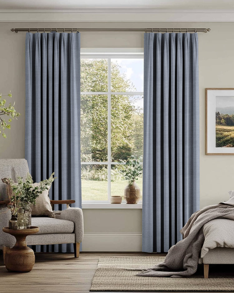 Elegant blue-grey Sally Linen Blend custom drapery with a pleated header, offering tailored light control and sophisticated home aesthetics.
