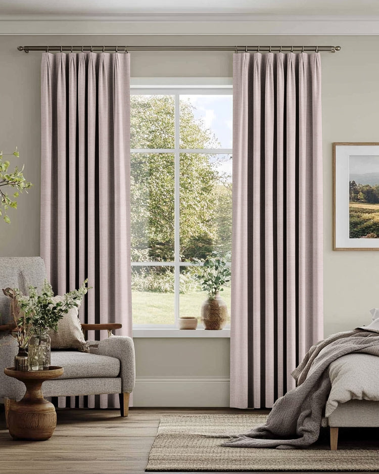 Blush pink custom Sally linen blend drapery with tailored pleats, framing a window for light control & sophisticated home aesthetics.