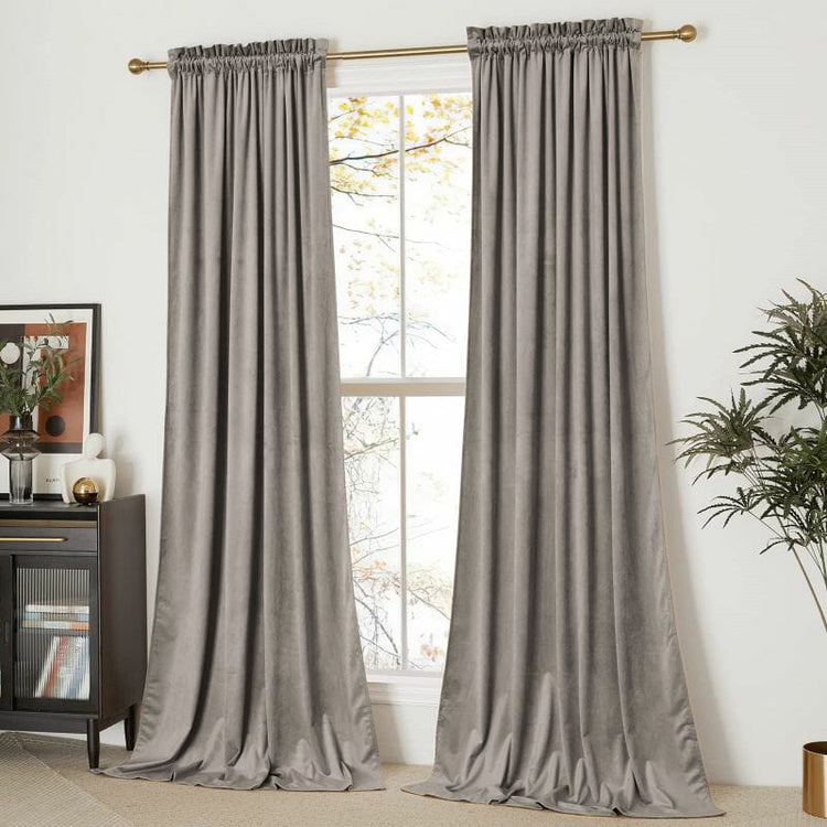 Custom grey velvet curtains with a gathered rod pocket header on a gold rod, elegantly styled for luxury home window treatments.