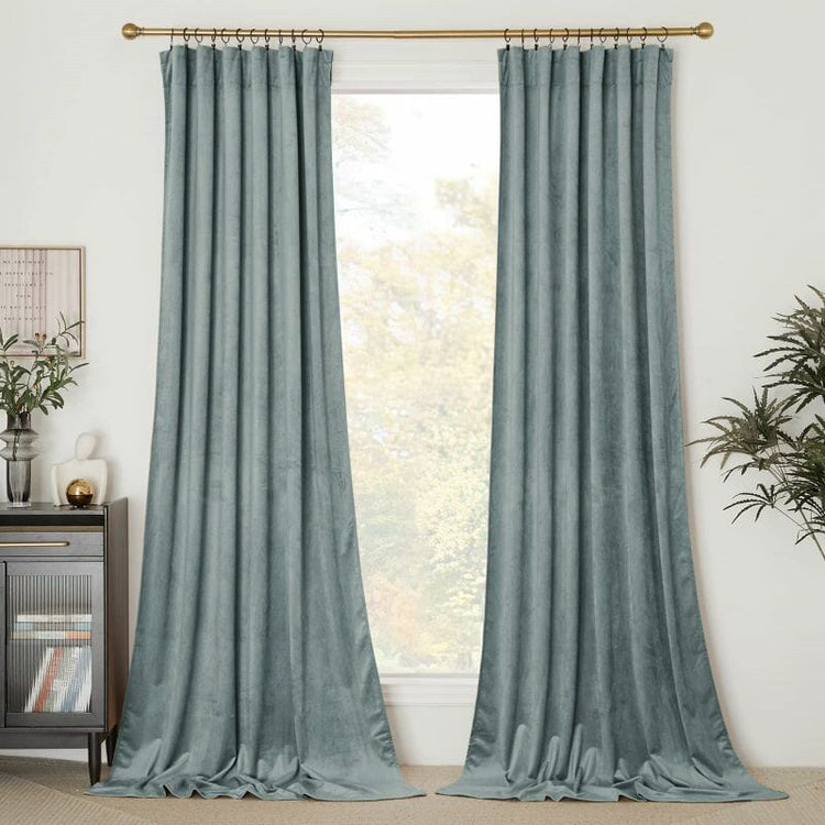 Classic teal velvet custom curtains with tailored pinch pleat header on a gold rod for luxury window treatments.