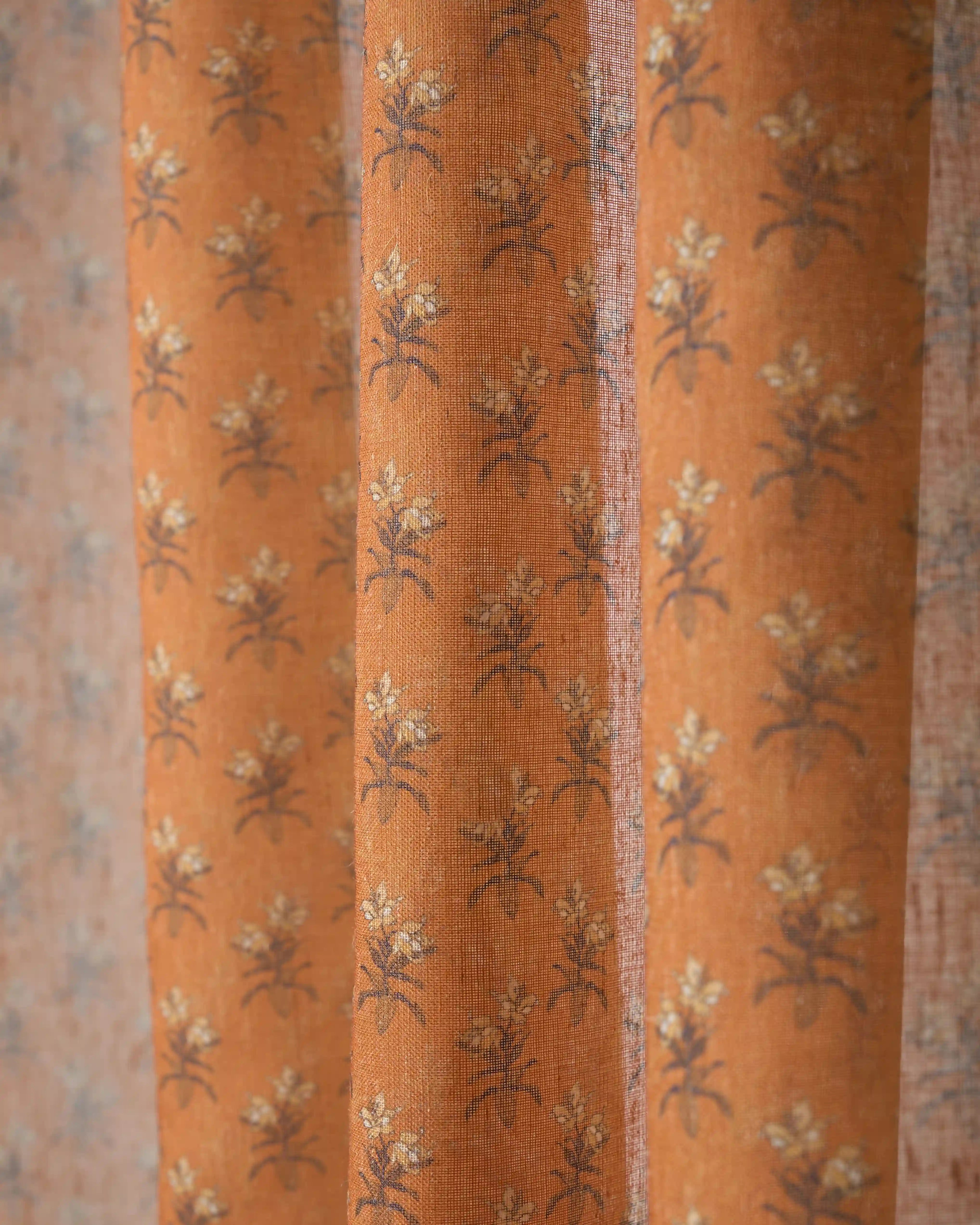 Burnt orange Rhythm Floral patterned sheer fabric swatch with a delicate floral print for custom window treatments.