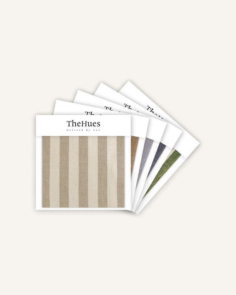 TheHues Milano linen blend striped fabric swatch in beige & off-white, fanned with other custom drapery fabric samples.