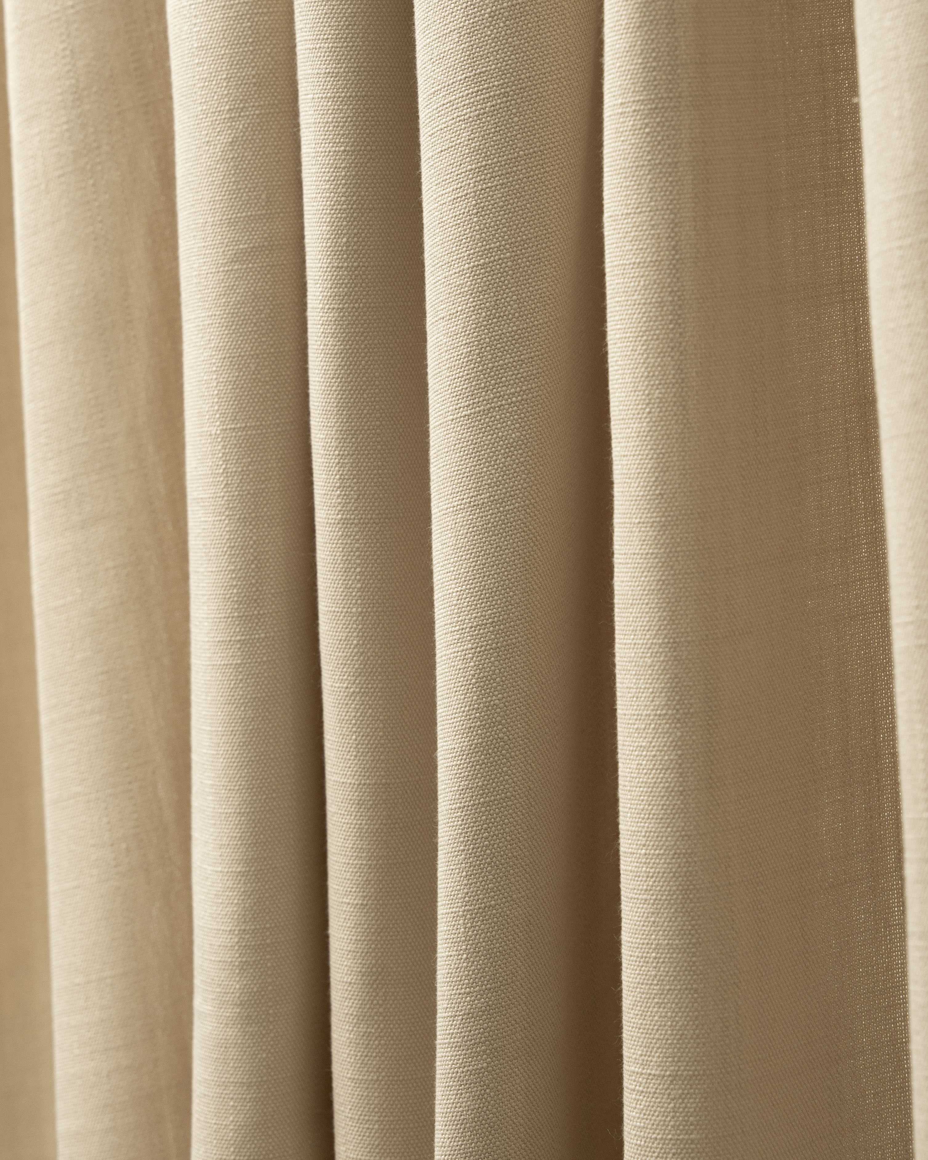 Close-up of Voy Linen Look Custom Curtain fabric in natural beige, showing its fine texture and elegant folds.