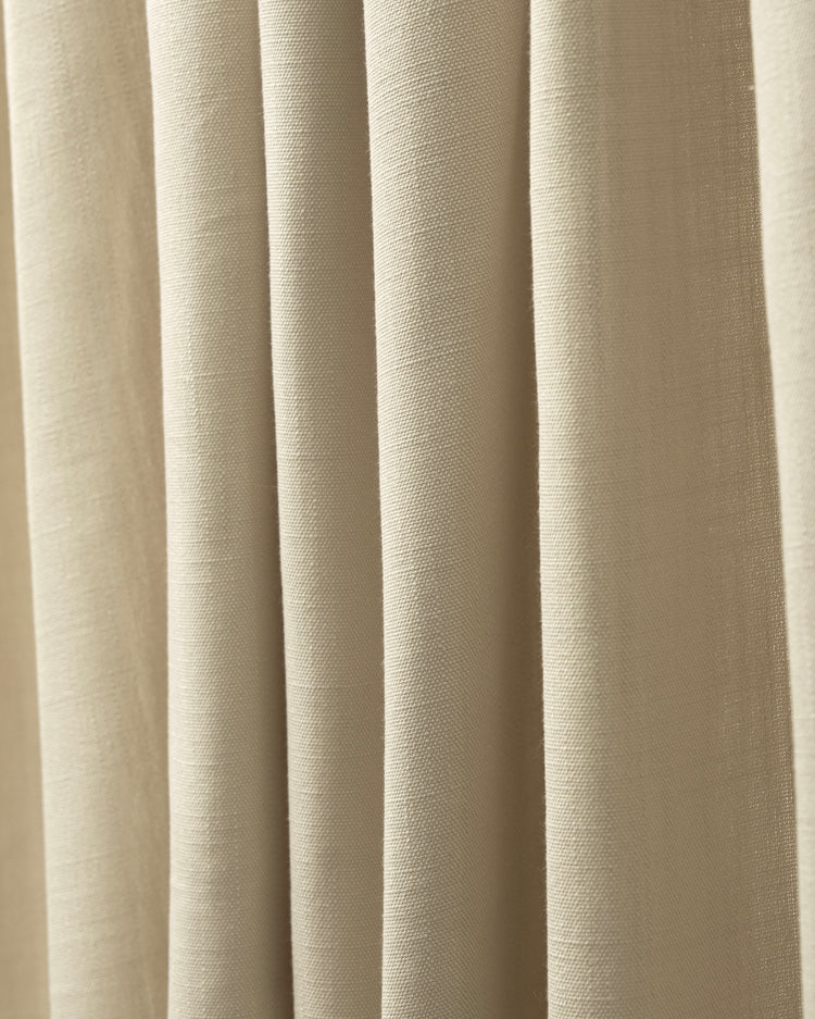 Close-up of Voy custom curtain fabric, showcasing natural beige linen-look weave with elegant soft drapes and texture.
