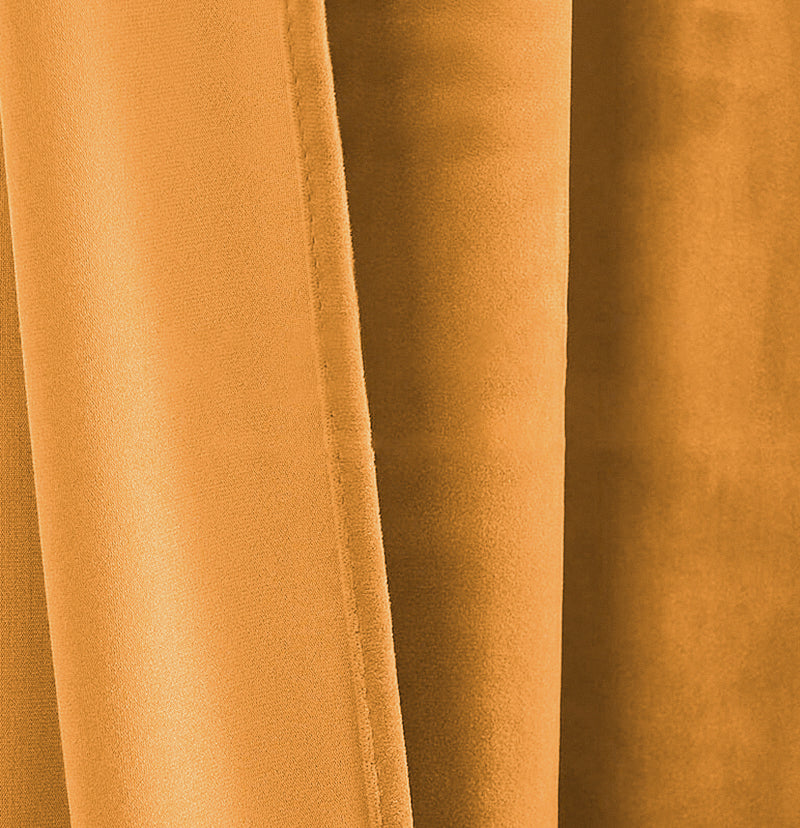 Luxurious golden velvet custom curtain fabric, showcasing soft, rich texture and elegant folds of the drapery.