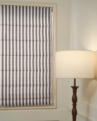 Milano Flat Fold Linen Blend Custom Roman Shade with vertical navy and natural linen stripes, neatly installed in a window.