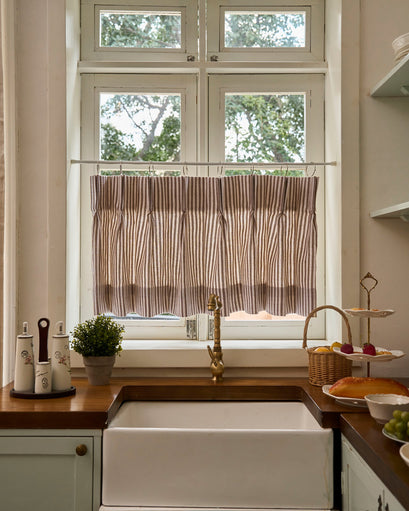 Elegant Milo Linen Blend Striped Custom Cafe Curtain providing privacy and soft light in a sophisticated farmhouse kitchen setting.