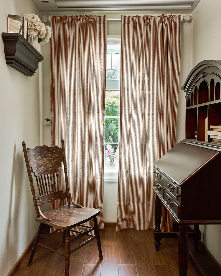Custom Milo Linen Blend Striped Curtains in a home study, providing elegant privacy and light filtering for an arched window with a garden view.