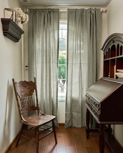 Custom striped Milo linen blend curtains with unfussy grace & grainy texture, perfectly tailored for light control in a serene room.