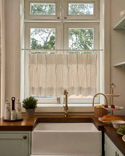 Milo Linen Blend Striped Custom Cafe Curtain on a kitchen window above a farmhouse sink, offering tailored privacy & light control.
