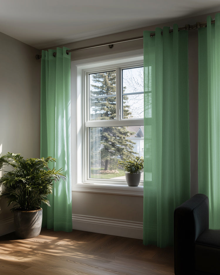 Light green yarn linen look sheer custom curtains with grommet top, hanging on a window, enhancing home decor.