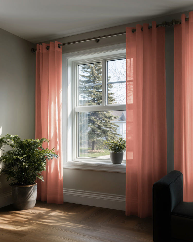 Light coral yarn linen look sheer custom curtains with grommet headers, letting natural light filter into a cozy room