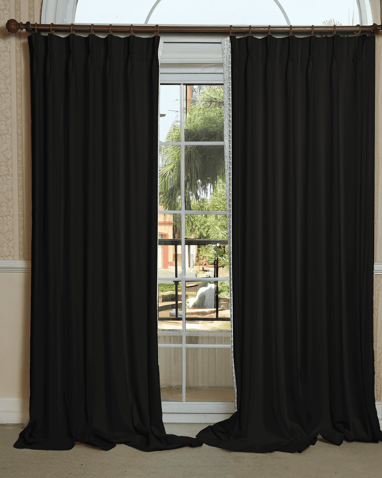 Black Zane custom drapery with elegant textured trim, open on an arched window, balancing privacy and light control.