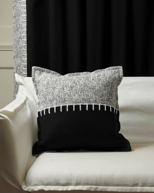Zane wool blend black & grey yarn stitched throw pillowcase on white sofa; custom blackout curtain with textured trim.