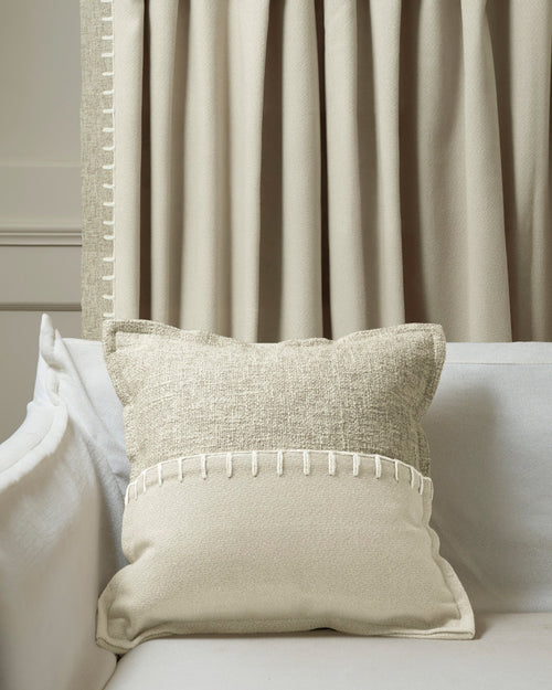 Zane wool blend throw pillowcase with dual textures & white yarn-stitch trim on a sofa, coordinating with custom drapery panel.