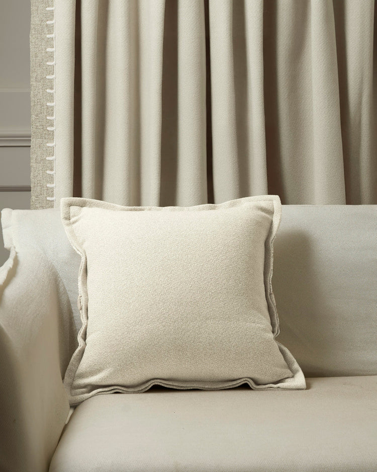 Cream Zane Wool Blend Yarn Stitched Throw Pillowcase on sofa, complementing textured neutral custom drapery for sophisticated home decor.