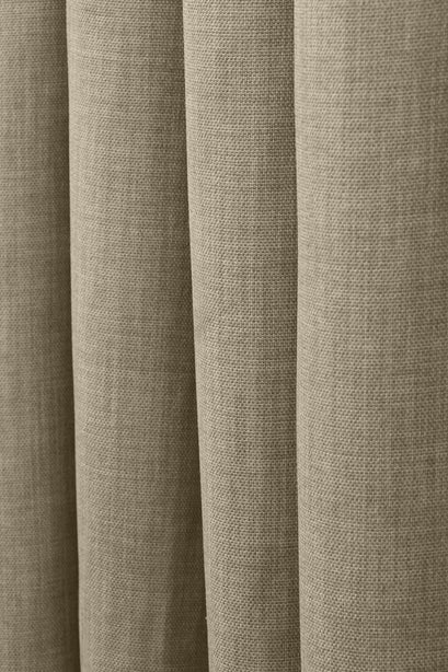 Detail of Zoe custom curtain, showcasing the soft, textured linen-look fabric in a natural taupe hue with elegant drapes.