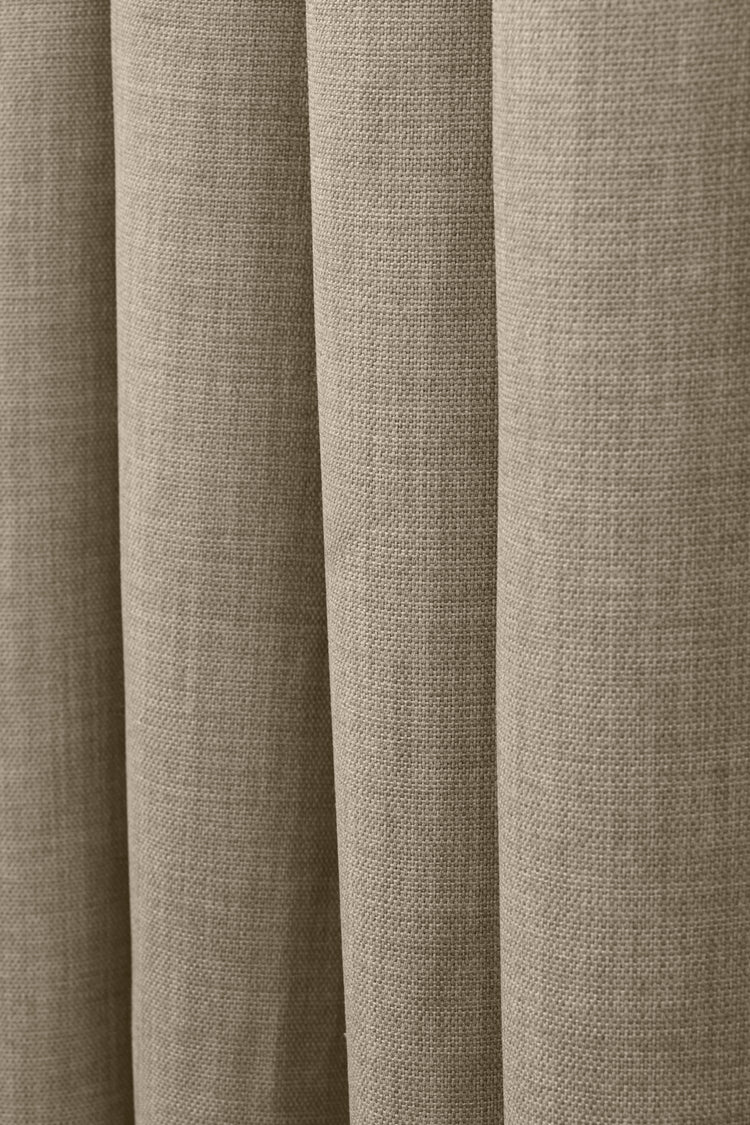 Detail of Zoe custom curtain, showcasing the soft, textured linen-look fabric in a natural taupe hue with elegant drapes.