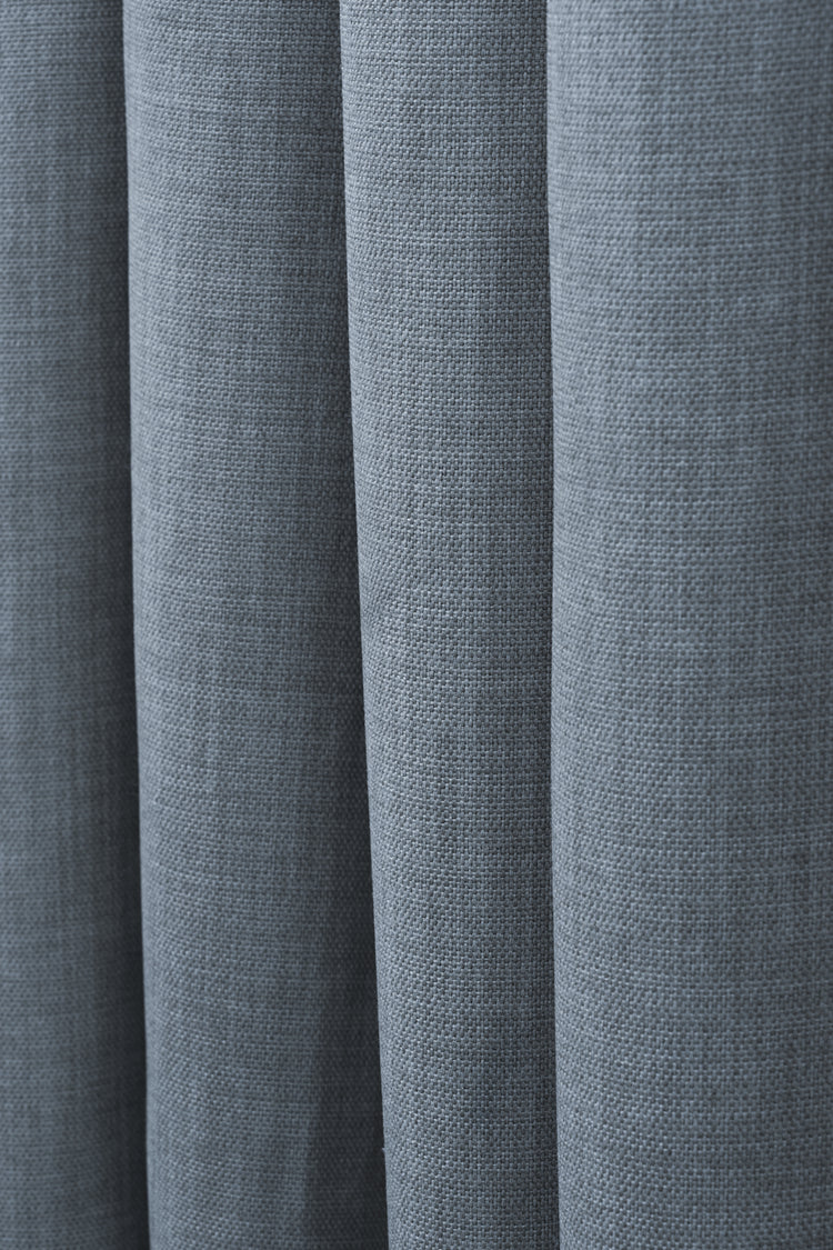 Close-up of a slate blue Zoe linen look custom curtain, highlighting its soft, textured fabric and elegant drapery folds.