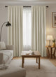 Zoe linen-look custom curtain in light beige, gathered header, layered over sheers in a modern living room for privacy & light control.