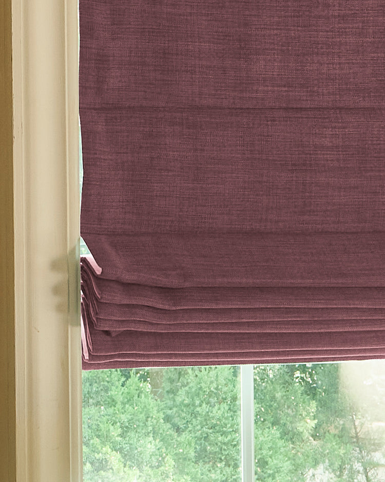 Zoe Plain Fold Custom Roman Shade. Close-up of deep red linen-look fabric, showcasing textured weave and neat, elegant folds.