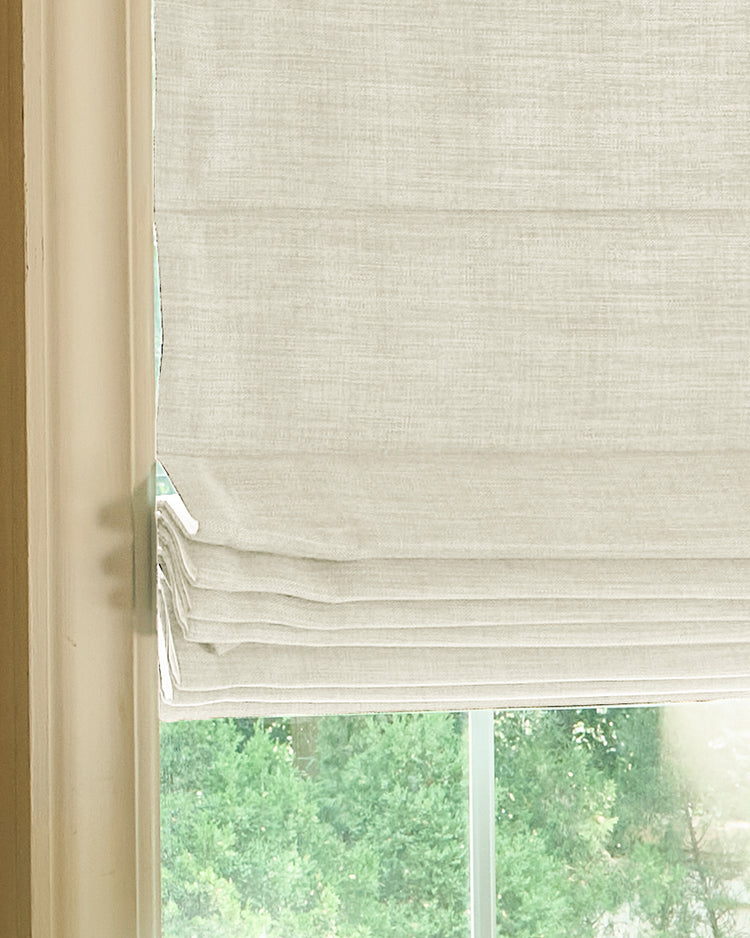 Zoe Plain Fold Linen Look Custom Roman Shade in cream, showcasing its textured fabric and neat pleats, ideal for tailored window treatments.
