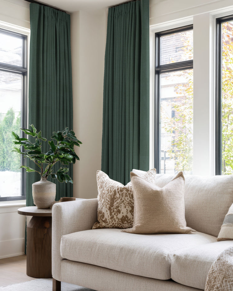 Zoe dark green 100% blackout linen look custom curtains with pinched pleat header, enhancing privacy and style in a modern living room.